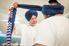 Sikh groom getting some help to wrap his turban. Sikh groom getting some help to wrap his turban.