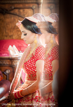 Sikh bride getting some help with her wedding attire. Sikh bride getting some help with her wedding attire.