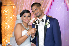 Happy couple posing with their customized cake topper. indian wedding cakes,indian wedding,indian wedding planning and design,indian wedding floral and decor