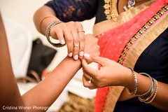 Indian bride getting some help with her jewelry. Indian bride getting some help with her jewelry.