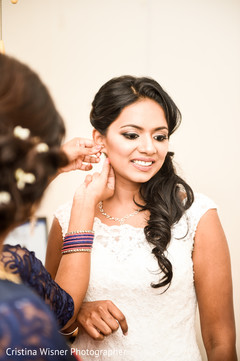 Stunning bride being assisted with her jewels. Stunning bride being assisted with her jewels.