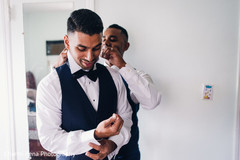 Indian groomsmen helping the groom to get ready for wedding ceremony Indian groomsmen helping the groom to get ready for wedding ceremony