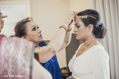 Lovely ladies helping indian bride to get ready for wedding ceremony Lovely ladies helping indian bride to get ready for wedding ceremony