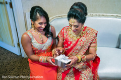 Indian bride opens a present from the groom. Indian bride opens a present from the groom.