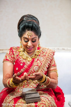 Candid moment of bride opening a present from the groom. Candid moment of bride opening a present from the groom.