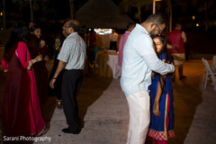 Indian groom and his daughter dancing at sangeet ceremony Indian groom and his daughter dancing at sangeet ceremony