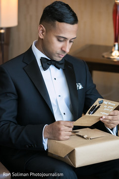 Groom reading love note Groom reading love note