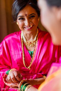 Bride getting some help with her jewelry. Bride getting some help with her jewelry.