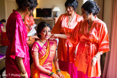 Indian bride getting some help from her bridesmaids. Indian bride getting some help from her bridesmaids.