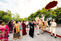 Indian groom escorted by family and friends. indian groom,indian wedding baraat,indian pre-wedding celebrations