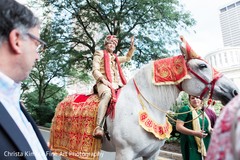 Indian groom riding the white baraat horse. indian wedding baraat,indian groom,indian pre-wedding celebrations