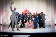 Indian couple and groomsmen taking a selfie at wedding reception Indian couple and groomsmen taking a selfie at wedding reception