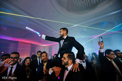 Indian groomsmen carrying the groom at wedding reception Indian groomsmen carrying the groom at wedding reception