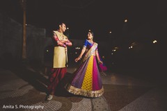 Bride and groom in colorful sangeet outfits. Bride and groom in colorful sangeet outfits.