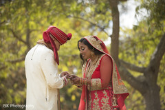 Indian groom putting engagement ring on bride’s right hand Indian groom putting engagement ring on bride’s right hand