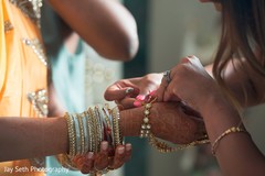 Bride getting some help with her jewelry. indian bride,indian bride makeup,indian bridal jewelry