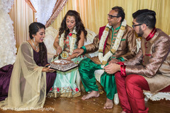 Indian brides mother cutting a cake at sangeet ceremony Indian brides mother cutting a cake at sangeet ceremony