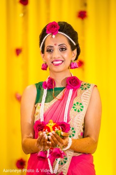 Indian bride holding flowers at haldi ceremony indian bridal fashions,indian bride makeup,indian bridal mehndi