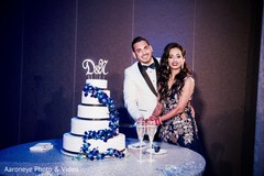Indian couple cutting the cake at wedding reception indian wedding design,indian bridal lengha,indian wedding photography