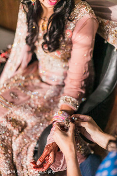 Bride getting some help with her outfit. pakistani bride,indian wedding jewelry,indian bride getting ready