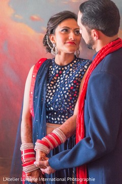 Bride and groom in blue and red matching outfits. indian pre-wedding fashion,indian bride,indian groom