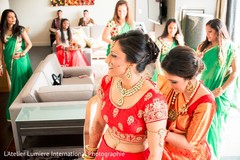 Getting extra help with the accessories. indian bride,indian bridal hair and makeup,indian wedding jewelry