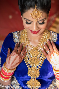 Indian bride showing her jewelry and mehndi art Indian bride showing her jewelry and mehndi art