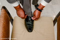 Indian groom tying his shoes before wedding ceremony Indian groom tying his shoes before wedding ceremony