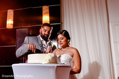Indian couple cutting the cake at wedding reception indian wedding design,indian wedding cakes,indian bride hair and makeup
