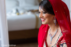 Indian bride wearing a red dupatta. indian bride,indian bride getting ready,indian bridal hair and makeup,dupatta