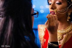 Bride getting some lip color. indian bride,indian bride getting ready,indian bride makeup