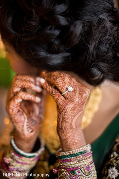 Indian bride trying her earrings before wedding ceremony Indian bride trying her earrings before wedding ceremony