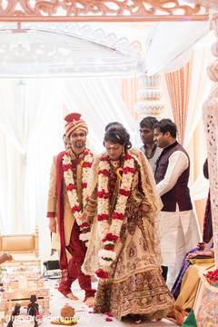Indian couple walking at wedding ceremony indian groom turban,indian bridal lengha,indian wedding ceremony floral and decor
