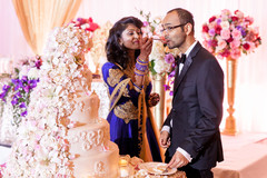 Indian couple eating cake at wedding reception Indian couple eating cake at wedding reception