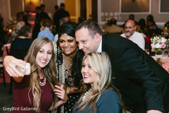 Indian couple and their friends taking a selfie at wedding reception Indian couple and their friends taking a selfie at wedding reception