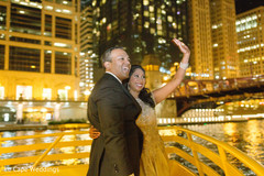 Indian couple saying hello to their friends outside wedding reception indian bride and groom portrait,bride bangles,mehndi art
