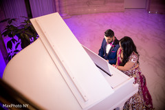 Indian couple playing piano photography indian bride hair and makeup,bridal tikka,indian wedding reception photography
