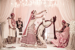 Indian couple exchanging jaimalas at wedding ceremony Indian couple exchanging jaimalas at wedding ceremony