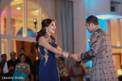 Indian couple dancing at sangeet ceremony Indian couple dancing at sangeet ceremony