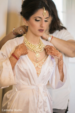 Indian lady helping the bride to get ready for wedding ceremony Indian lady helping the bride to get ready for wedding ceremony