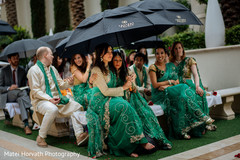 Bridesmaids covering from the rain Bridesmaids covering from the rain