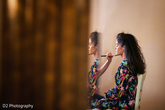 Makeup artist working on bride before wedding ceremony