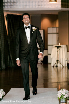 Elegant groom entering the ceremony venue. Elegant groom entering the ceremony venue.