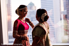 Bride's mother helping indian bride to get ready for ceremony Bride's mother helping indian bride to get ready for ceremony