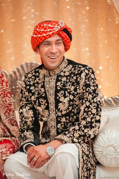 Indian groom smiling photography at wedding reception Indian groom smiling photography at wedding reception