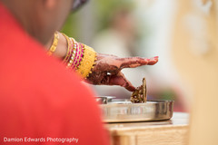 Indian bride touching little ganesh statue at wedding ceremony mehndi art,bridal jewelry,indian wedding gallery
