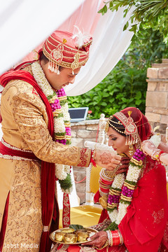 Lovely indian couple photography at wedding ceremony indian bride lengha,indian groom outfit,indian wedding ceremony floral and decor