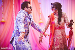 Indian couple enjoying the dance at sangeet ceremony indian groom sherwani,indian bride lengha,indian bride hair and makeup