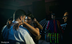 Indian bride and groom dancing at wedding reception party