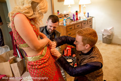 Getting ready. getting ready,groomsmen,red sari,indian wedding